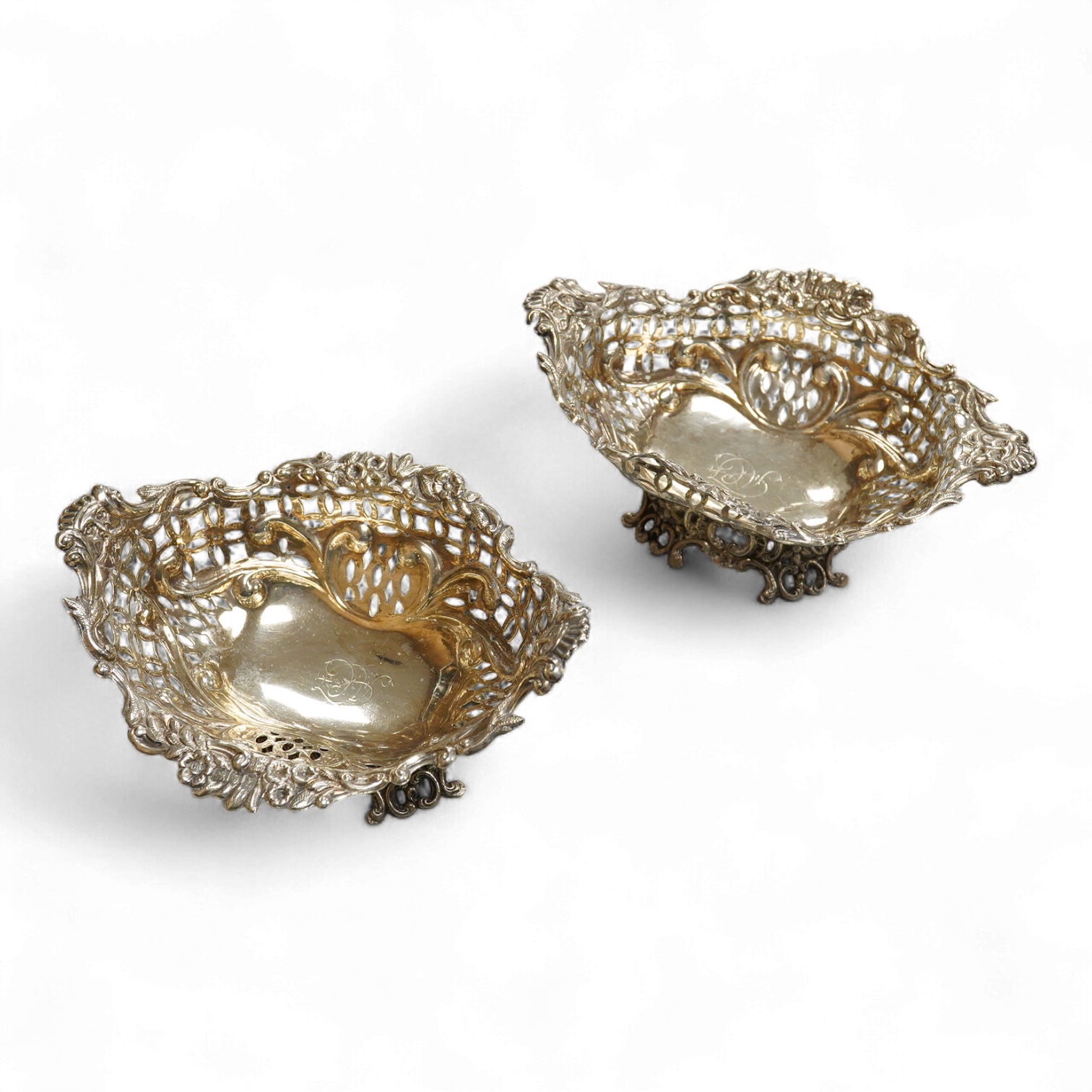 A pair of late Victorian pierced silver boat shaped bonbon dishes, with engraved monogram, by Charles Boyton II, London, 1897, length 16.4cm, 7.3oz.